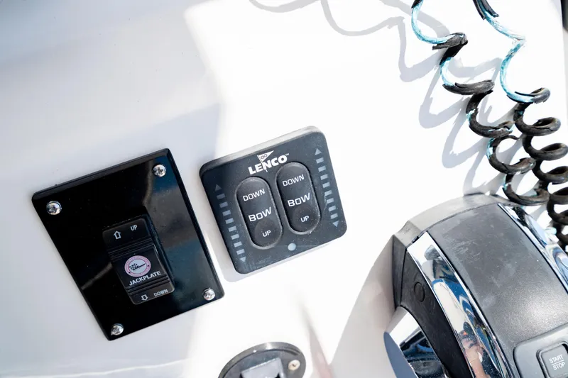 Slide: The Image of Control panel on 2015 Edgewater 240 Inshore boat with Lenco trim tab switches. - 25
