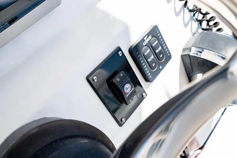 Slide: The Image of Control panel of 2015 Edgewater 240 Inshore boat with switches and steering wheel. - 26