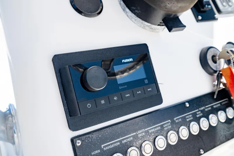 Slide: The Image of Control panel of 2015 Edgewater 240 Inshore boat with Fusion audio system. - 27