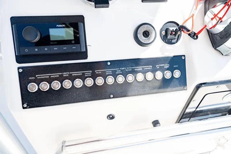 Slide: The Image of Control panel of 2015 Edgewater 240 Inshore boat with buttons and audio system. - 28