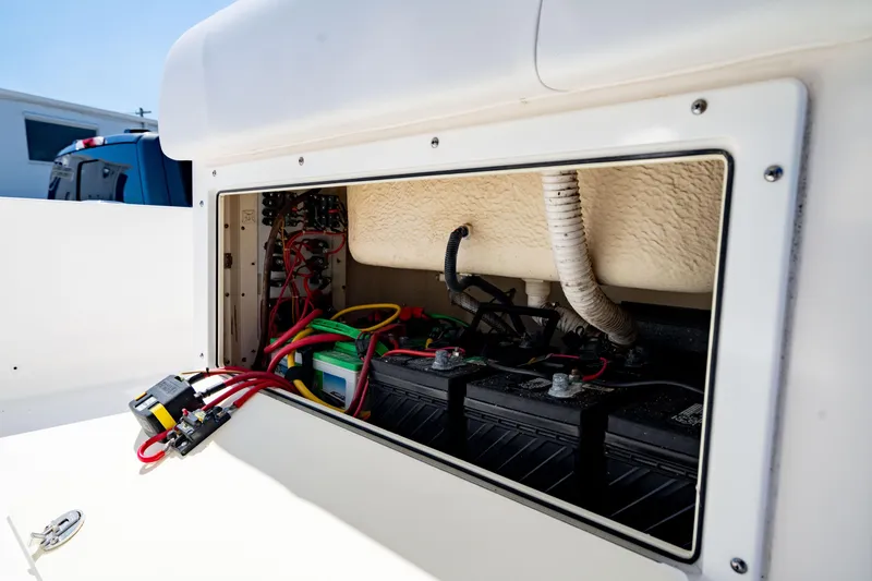 Slide: The Image of Battery compartment of a 2015 Edgewater 240 Inshore boat, showing wiring and connections. - 30