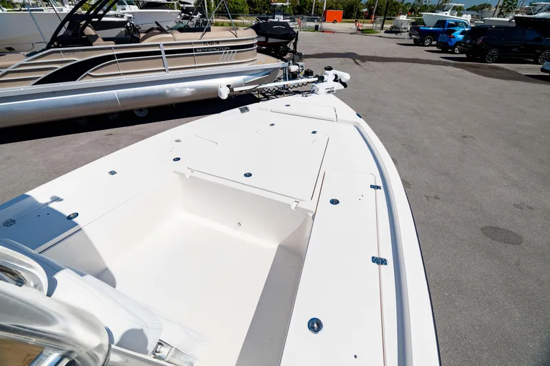 Slide: The Image of 2015 Edgewater 240 Inshore boat, white deck, parked outdoors in a marina. - 31