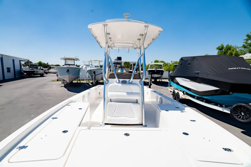 Slide: The Image of 2015 Edgewater 240 Inshore boat with T-top, docked under clear blue sky. - 32