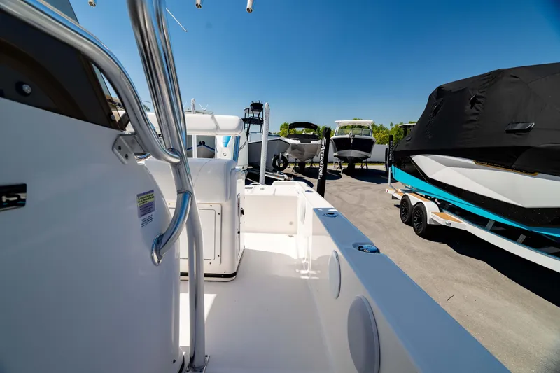 Slide: The Image of 2015 Edgewater 240 Inshore boat interior with docked vessels in background. - 38
