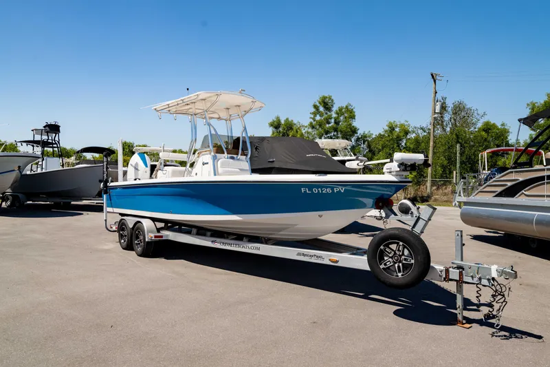 Slide: The Image of 2015 Edgewater 240 Inshore boat on trailer, parked outdoors under clear blue sky. - 40