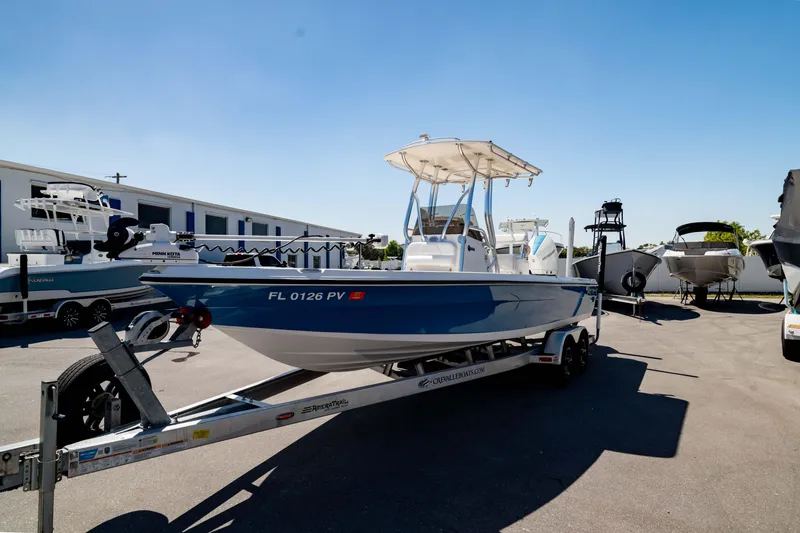 Slide: The Image of 2015 Edgewater 240 Inshore boat on trailer in sunny marina setting. - 42