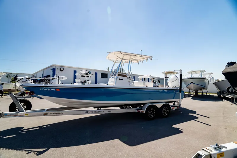 Slide: The Image of 2015 Edgewater 240 Inshore boat on trailer under clear blue sky. - 43