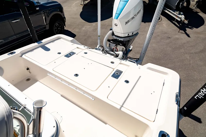 Slide: The Image of 2015 Edgewater 240 Inshore boat with Mercury outboard engine, parked on pavement. - 5