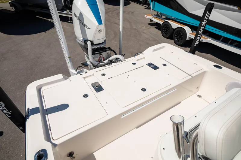 Slide: The Image of 2015 Edgewater 240 Inshore boat deck with motor and storage compartments. - 7