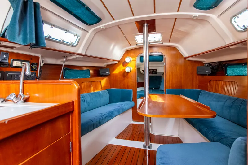 Slide: The Image of Interior of 1995 Beneteau Oceanis 321 sailboat with wood finish and blue upholstery. - 45