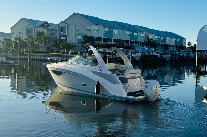 Slide: The Image of 2023 Regal 26XO boat docked in a serene marina setting. - 1
