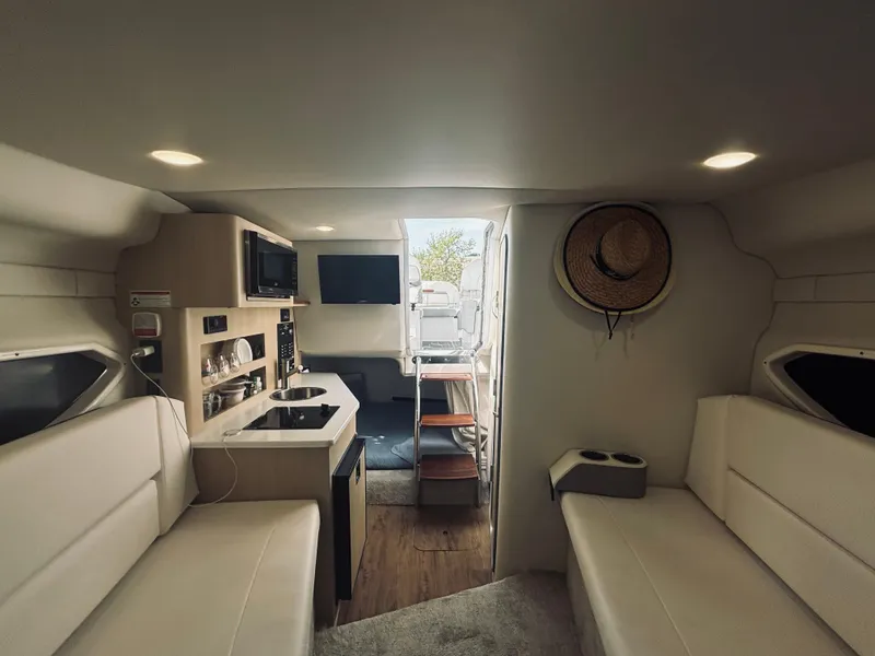 Slide: The Image of 2023 Regal 26XO boat interior with kitchenette, seating, and modern amenities. - 11