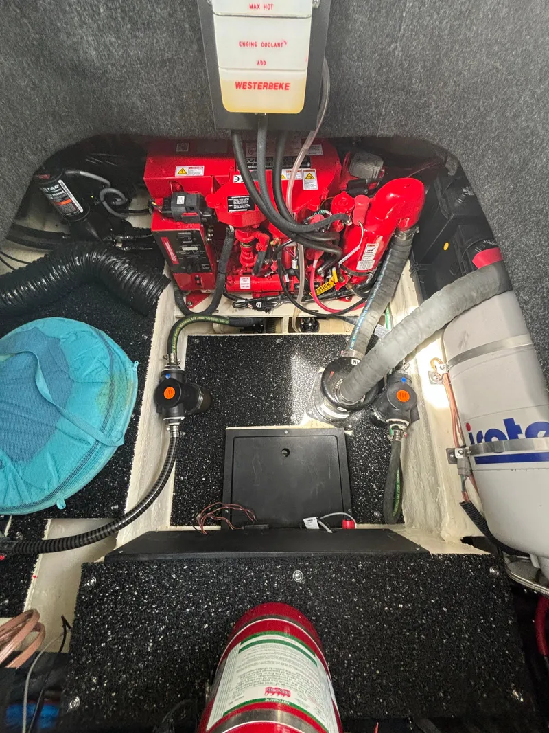 Slide: The Image of Engine compartment of 2023 Regal 26XO boat, featuring mechanical components and wiring. - 12