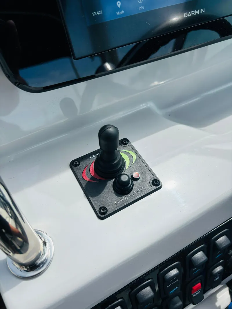 Slide: The Image of 2023 Regal 26XO boat dashboard with joystick control and Garmin display. - 13