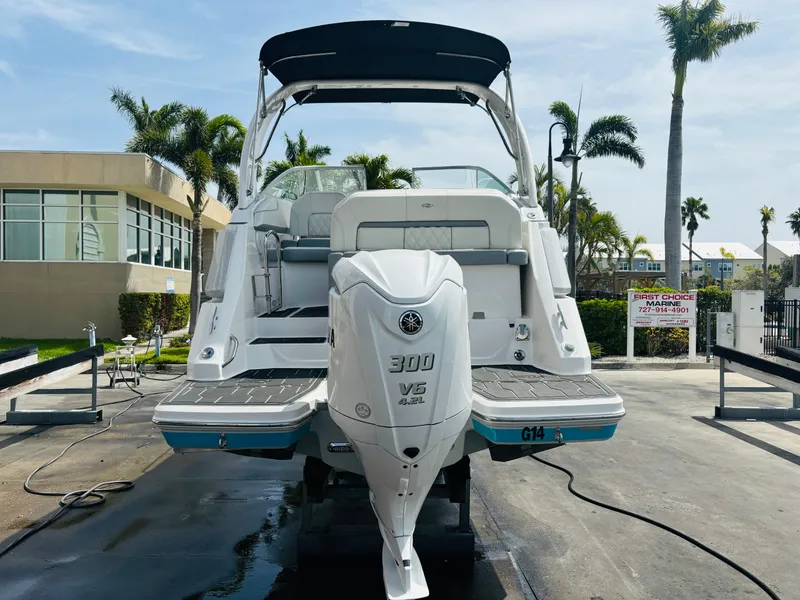 Slide: The Image of 2023 Regal 26XO boat with Yamaha 300 V6 engine, docked outdoors. - 4