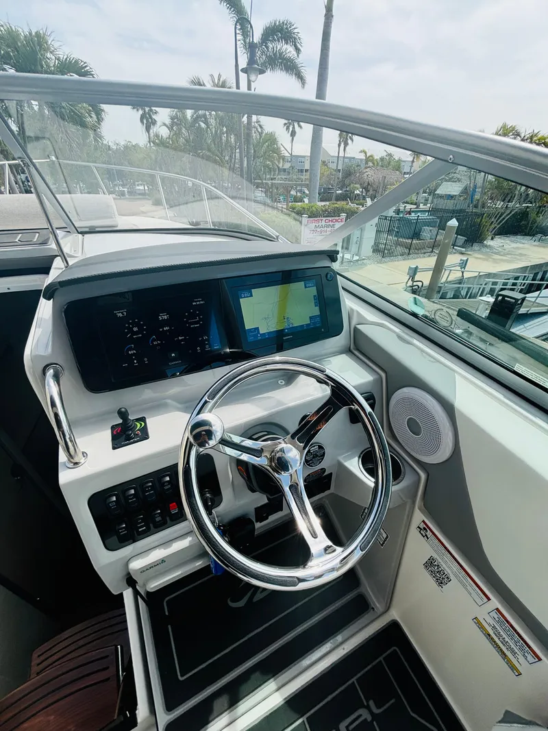 Slide: The Image of 2023 Regal 26XO boat cockpit with modern steering and digital display. - 7