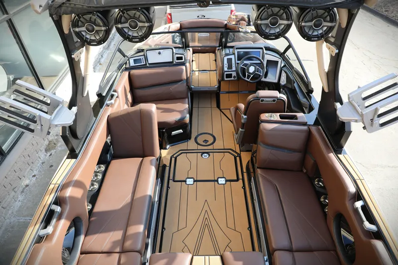 Slide: The Image of 2023 Supra SL boat interior with luxurious brown seating and advanced audio system. - 14