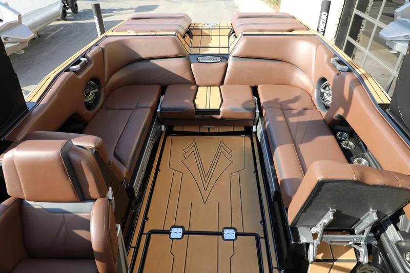 Slide: The Image of 2023 Supra SL boat interior with luxurious brown seating and stylish flooring design. - 20