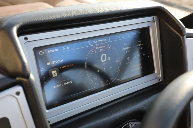 Slide: The Image of 2023 Supra SL dashboard display showing Bluetooth connectivity and speedometer. - 26