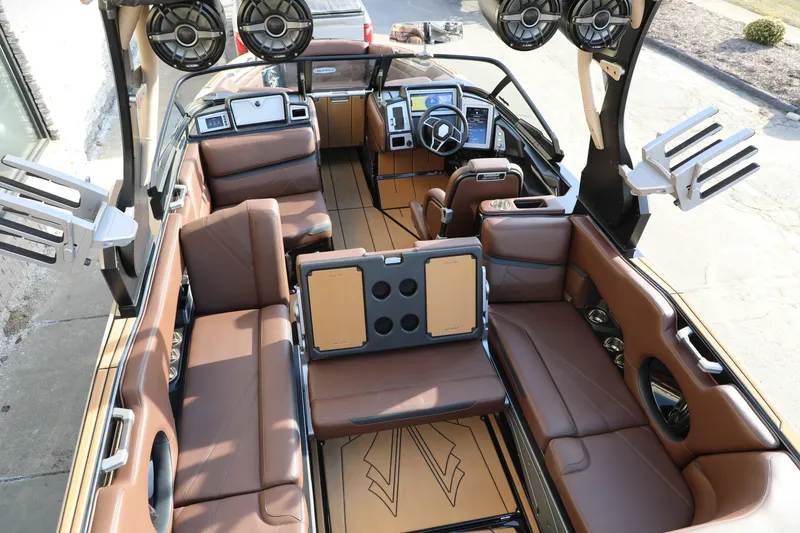 Slide: The Image of Luxurious interior of 2023 Supra SL boat with brown leather seating and advanced audio system. - 3