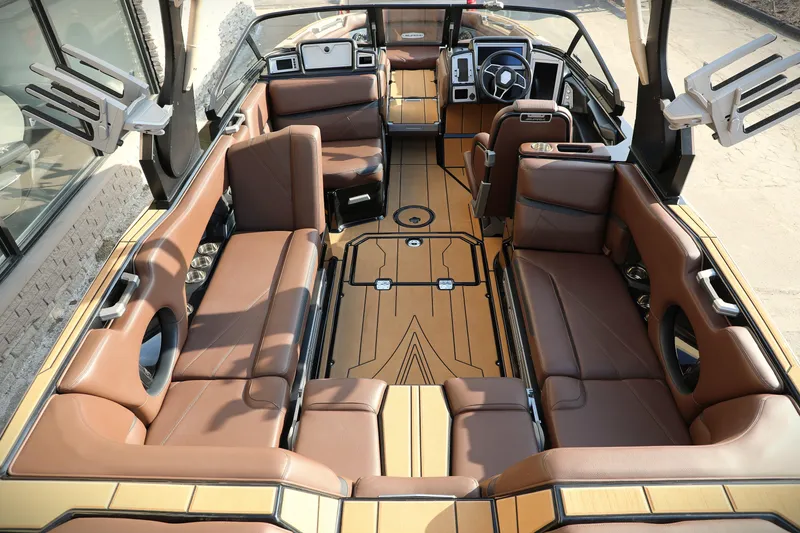 Slide: The Image of 2023 Supra SL boat interior with luxurious brown seating and modern dashboard design. - 6