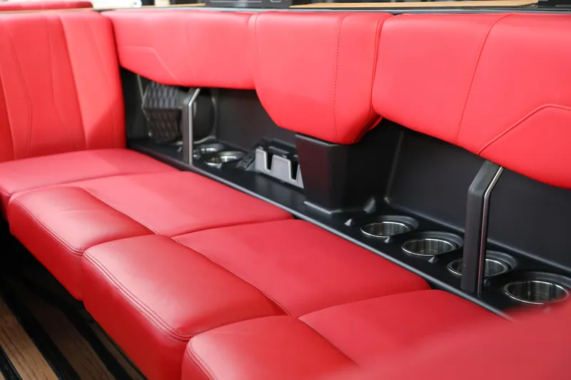 Slide: The Image of 2023 Malibu Wakesetter 22 LSV interior with red leather seating and cup holders. - 17