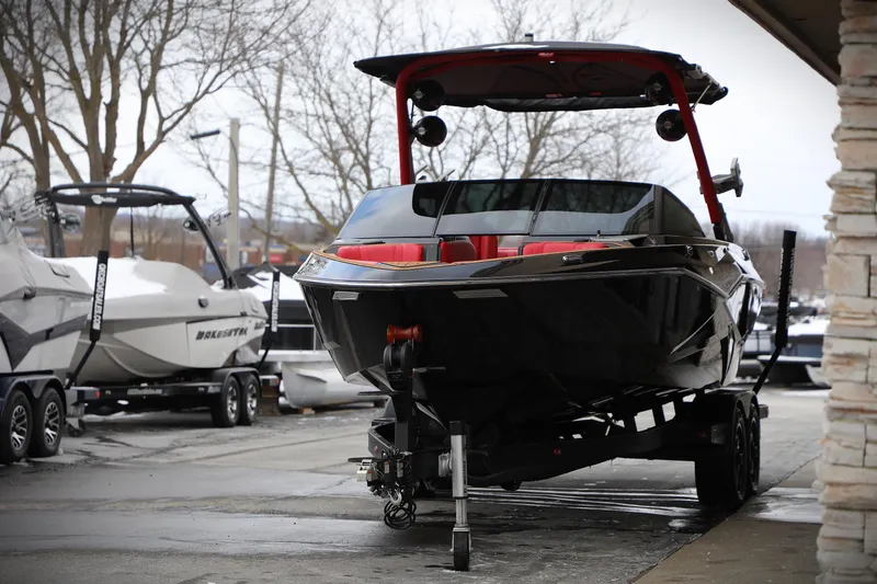 Slide: The Image of 2023 Malibu Wakesetter 22 LSV boat on trailer, parked outdoors. - 19