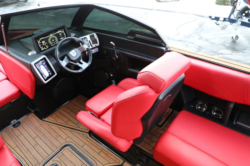 Slide: The Image of 2023 Malibu Wakesetter 22 LSV interior with red seats and modern dashboard. - 23
