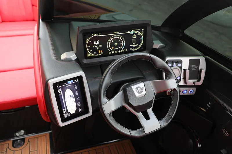 Slide: The Image of 2023 Malibu Wakesetter 22 LSV dashboard with digital displays and steering wheel. - 3