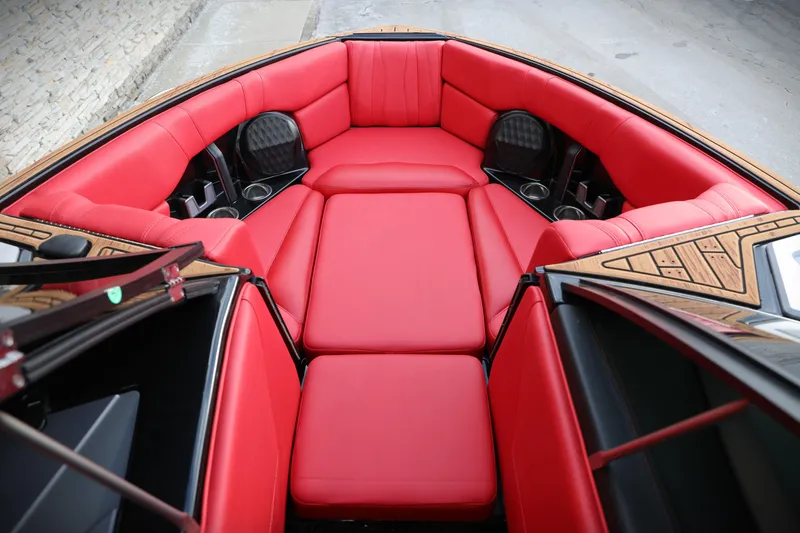 Slide: The Image of 2023 Malibu Wakesetter 22 LSV boat interior with vibrant red seating and cup holders. - 4