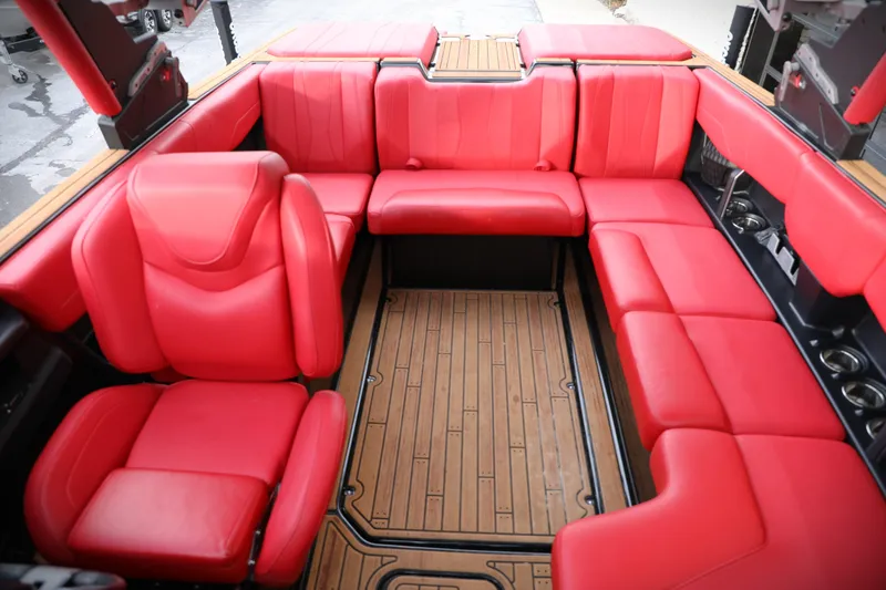 Slide: The Image of 2023 Malibu Wakesetter 22 LSV interior with vibrant red seating and wood flooring. - 5