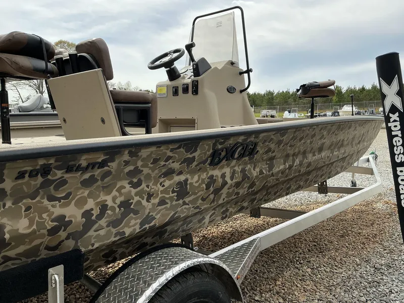 Slide: The Image of 2025 Excel Bay Pro 203 Elite boat with camouflage design on a trailer. - 6