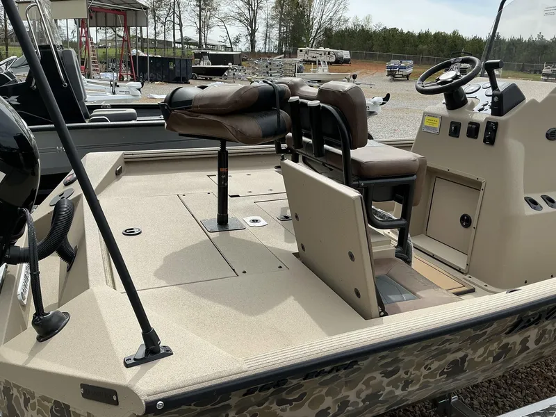 Slide: The Image of 2025 Excel Bay Pro 203 Elite boat interior with seating and steering console. - 8