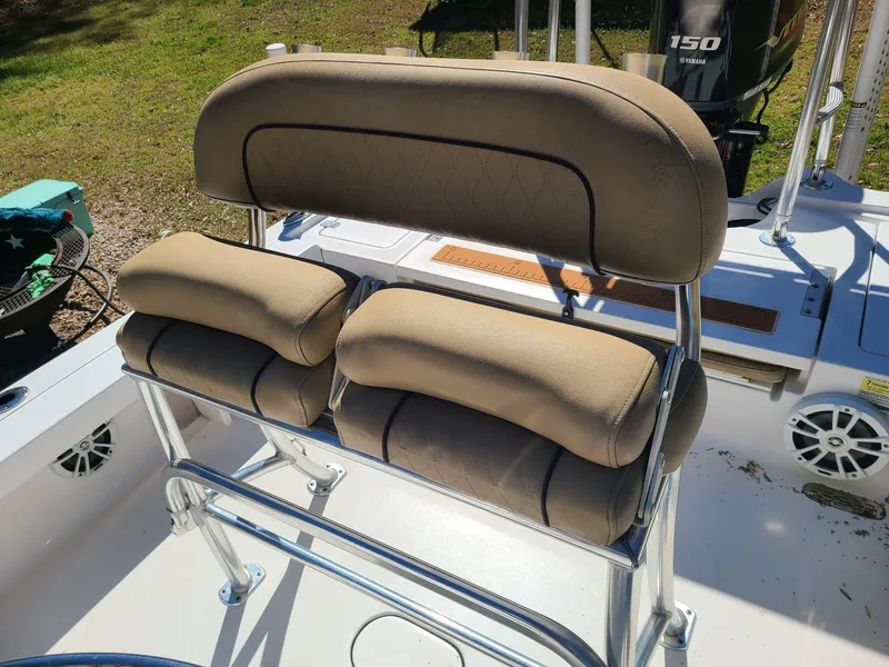 Slide: The Image of 2018 Sportsman TOURNAMENT 214 boat seat with beige cushions and stainless steel frame. - 17