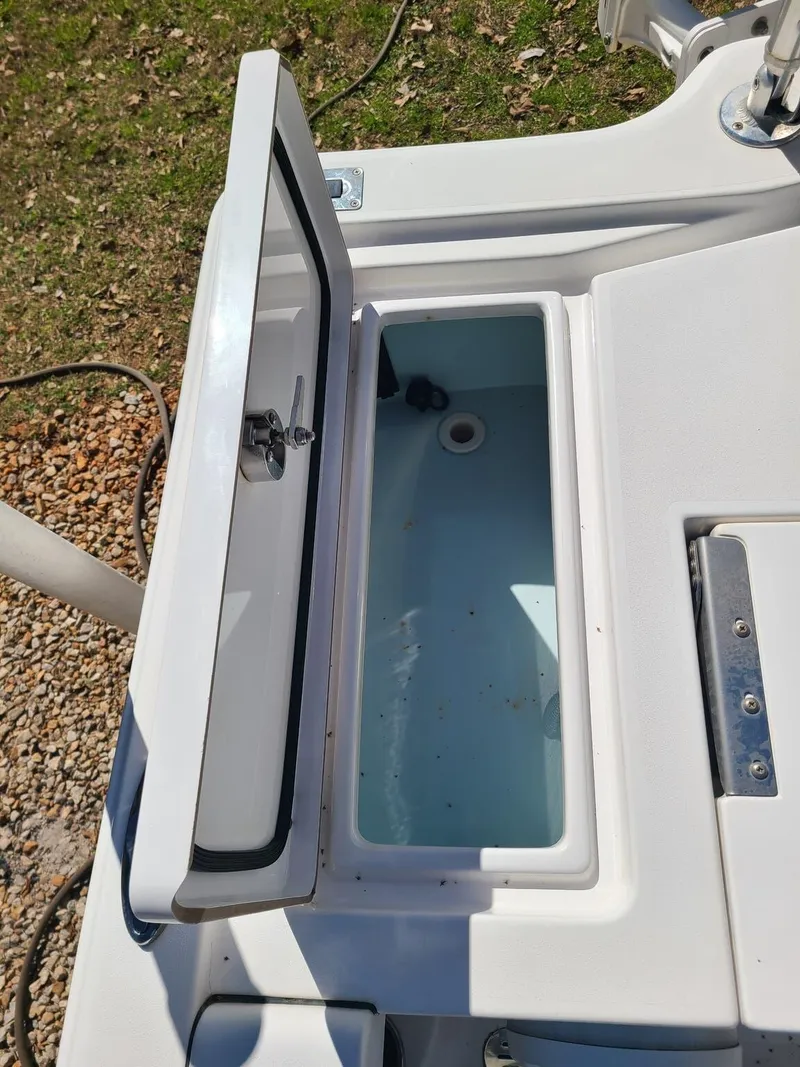 Slide: The Image of Open storage compartment on 2018 Sportsman TOURNAMENT 214 boat, showing interior details. - 19