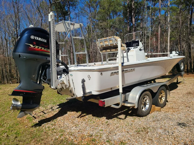 Slide: The Image of 2018 Sportsman TOURNAMENT 214 boat with Yamaha motor on trailer in wooded area. - 3