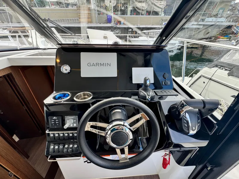 Slide: The Image of 2023 Jeanneau NC 1095 Fly helm with Garmin navigation system and modern controls. - 10