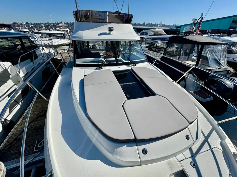 Slide: The Image of 2023 Jeanneau NC 1095 Fly yacht with spacious deck, docked among other boats. - 3