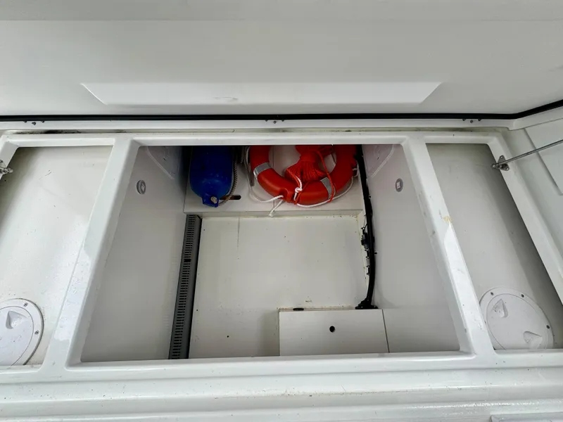 Slide: The Image of 2023 Jeanneau NC 1095 Fly storage compartment with life ring and equipment. - 5