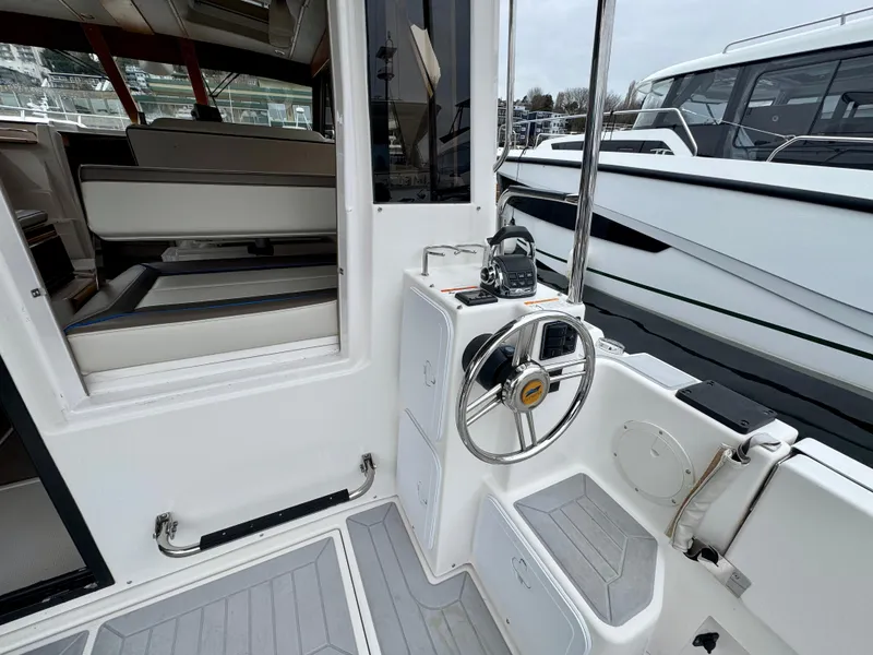 Slide: The Image of 2018 Cutwater C-30 CB boat helm with steering wheel and seating area. - 10