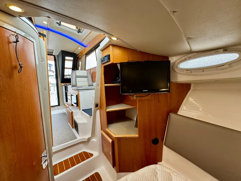 Slide: The Image of 2018 Cutwater C-30 CB interior with wood finishes, TV, and modern seating. - 21