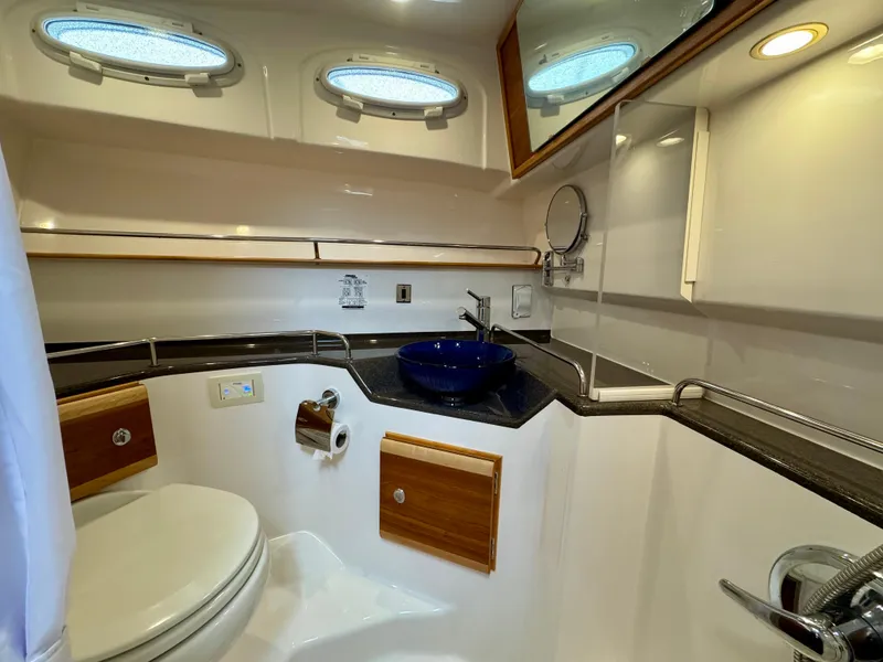 Slide: The Image of 2018 Cutwater C-30 CB yacht bathroom with modern fixtures and blue sink. - 22