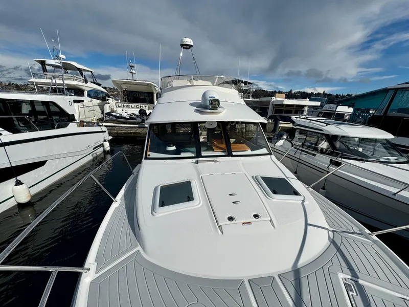 Slide: The Image of 2018 Cutwater C-30 CB boat docked at marina under cloudy sky. - 25