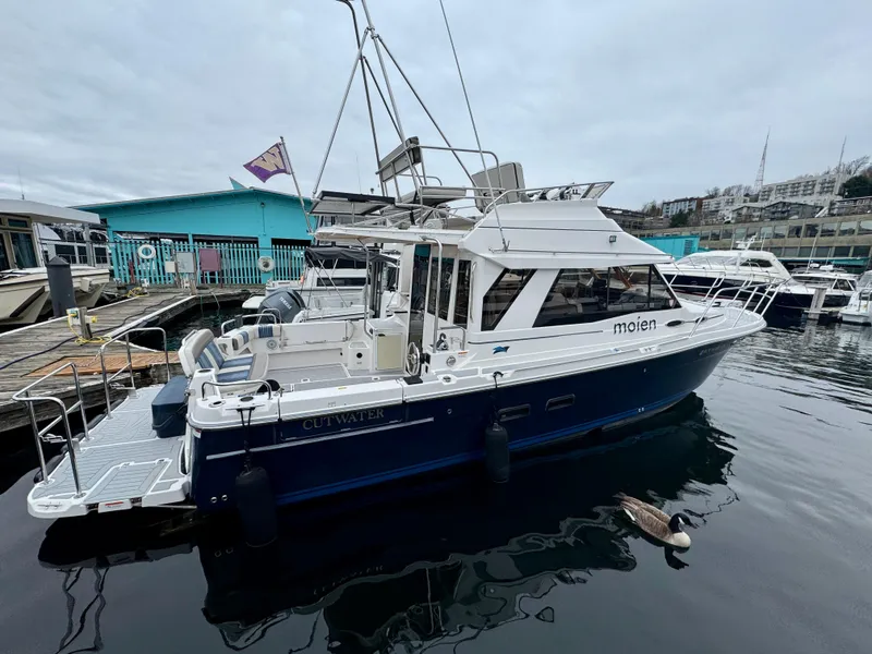 Slide: The Image of 2018 Cutwater C-30 CB boat docked at marina with overcast sky. - 3