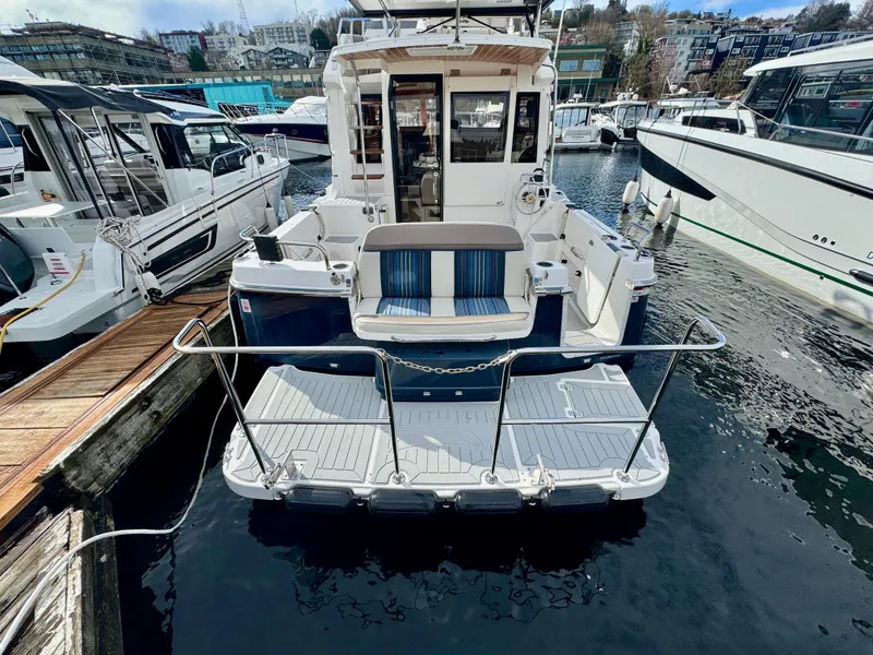 Slide: The Image of 2018 Cutwater C-30 CB boat docked, rear view with swim platform and seating. - 5