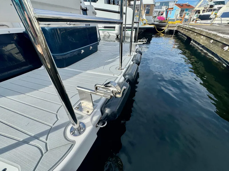 Slide: The Image of 2018 Cutwater C-30 CB boat docked, showing deck and railing details. - 8