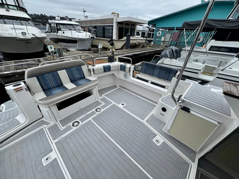 Slide: The Image of 2018 Cutwater C-30 CB boat with spacious deck and seating at marina. - 9