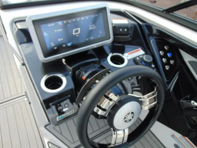 Slide: The Image of 2023 Yamaha Boats 252SD dashboard with touchscreen, steering wheel, and controls. - 28