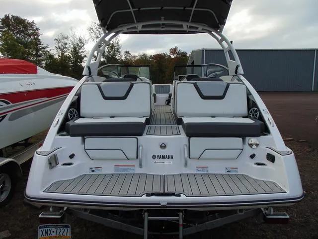 Slide: The Image of 2023 Yamaha Boats 252SD, rear view, showcasing seating and deck design. - 4
