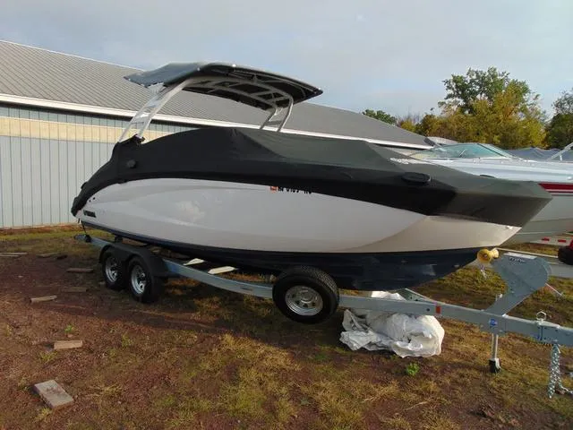 Slide: The Image of 2023 Yamaha Boats 252SD on trailer, parked outdoors near a building. - 5